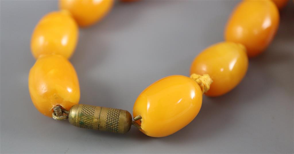 A single strand graduated oval amber bead necklace, 86cm, gross weight 112 grams,
